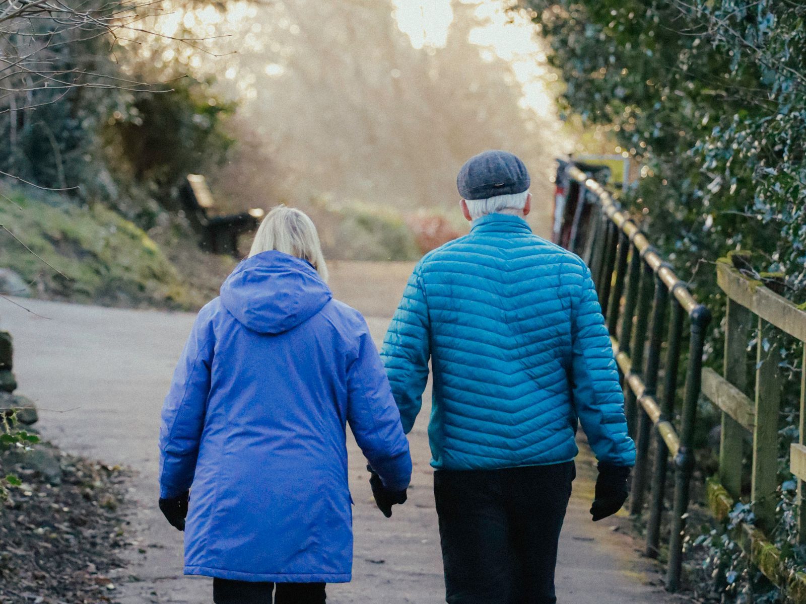 Two people running outdoors at sunset, active and well